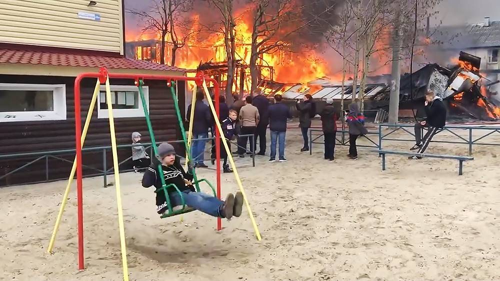 Невозмутимый мальчик на качелях на фоне пожара стал мемом