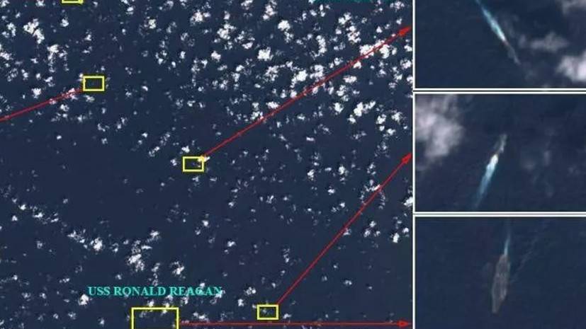Спутник заснял авианосец США в окружении кораблей Китая