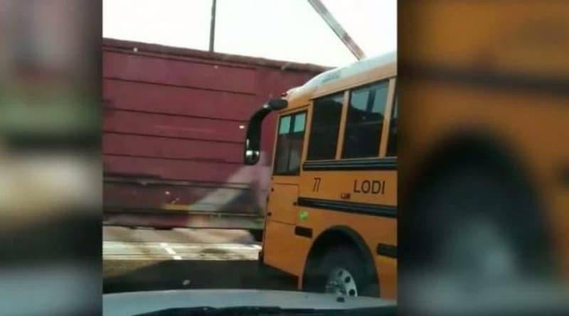 На жутком видео водитель школьного автобуса тормозит в нескольких дюймах от мчащегося грузового поезда