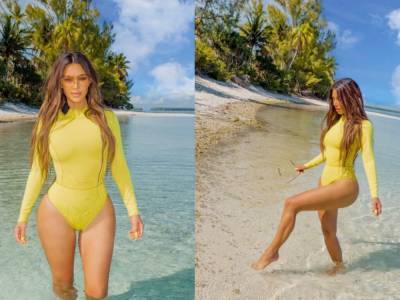 Ким Кардашьян в боди лимонного цвета нежилась на тропическом пляже