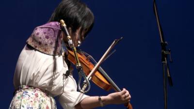 Музыкант из Японии играет на скрипке с протезом вместо руки.