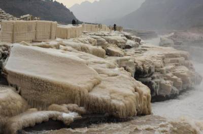 В Китае известный желтый водопад превратился в "нефритовый ледопад": впечатляющие фото