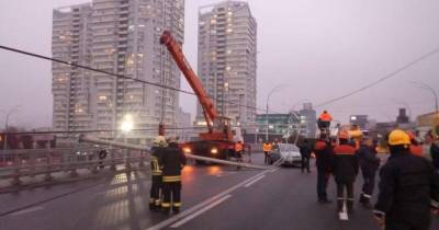 Столбы, которые упали на Шулявском мосту, повредили 9 автомобилей