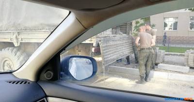 Военные грузят тротуарную плитку с улицы Ленина в свой КамАЗ