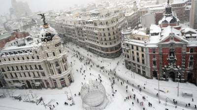 Столкнувшиеся с погодной аномалией жители Мадрида чистят снег с улиц сковородками