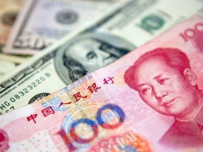 Центробанк Китая укрепил курс юаня к доллару до максимального с июня уровня