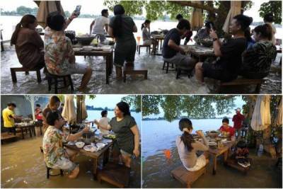 Ресторан в Таиланде затопила река: гости обедают по колено в воде и им нравится