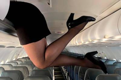 Стюардесса свесила ноги с багажной полки в мини-юбке и восхитила поклонников