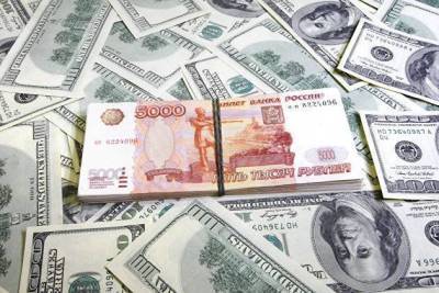 Средневзвешенный курс доллара к рублю расчетами "завтра" снизился дов 73,69 рубля