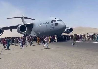 Афганцы пытаются покинуть Кабул на фюзеляжах самолетов