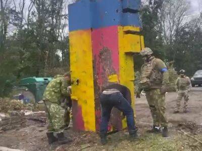"Убирают за собой мусор". Пленные оккупанты в Купянске перекрасили стелу в цвета украинского флага вместо российского. Видео